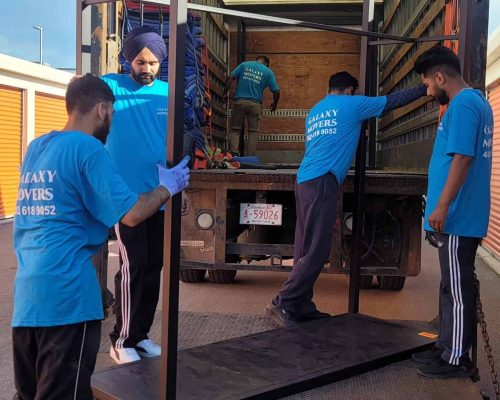 Galaxy Movers carrying furniture carefully through contemporary home