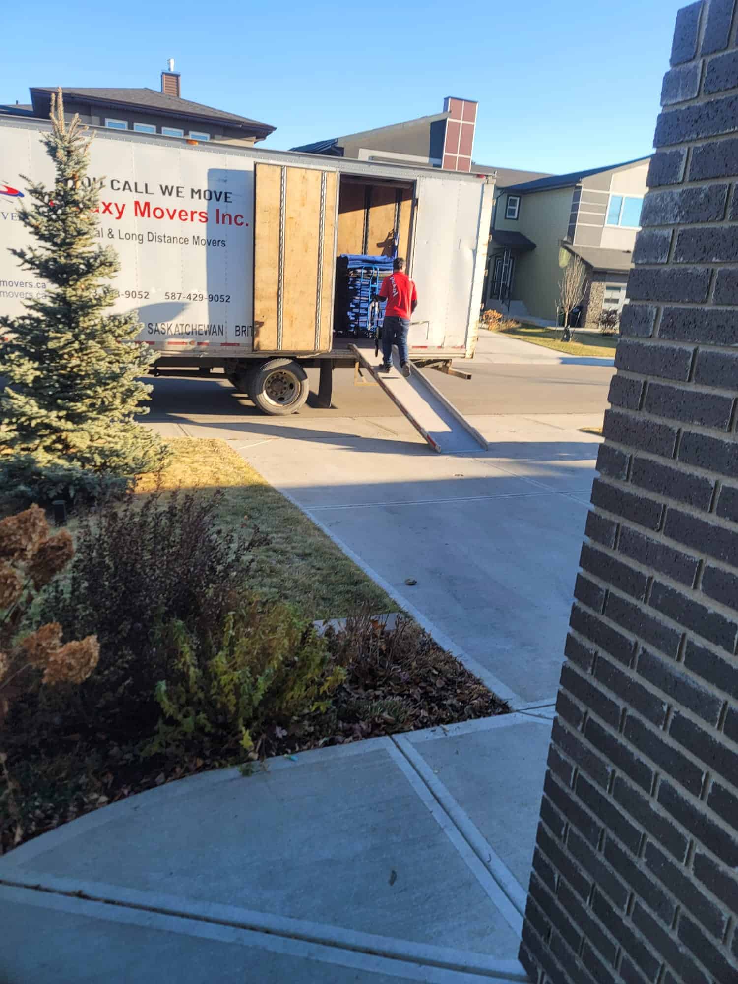 Moving truck traveling on scenic Canadian highway for long-distance relocation